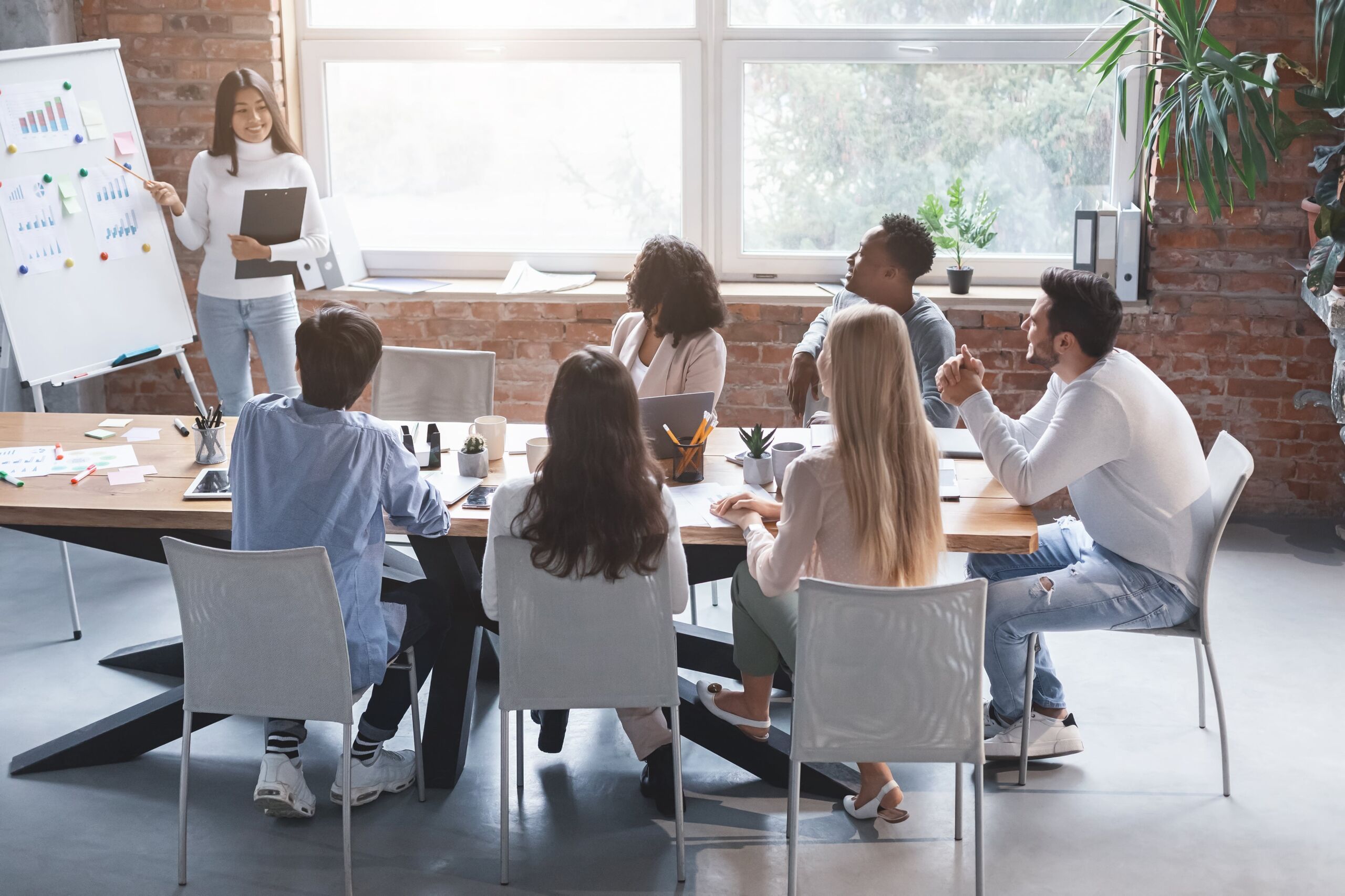 Female doing a Business Presentation to her team.