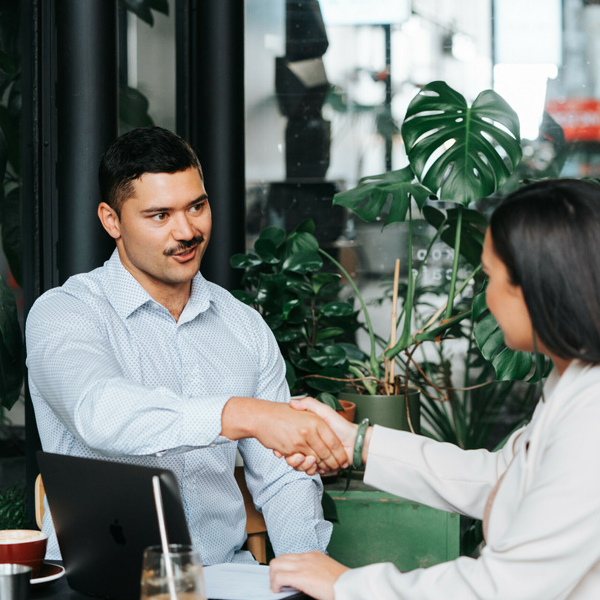 two people shaking hands during an interview