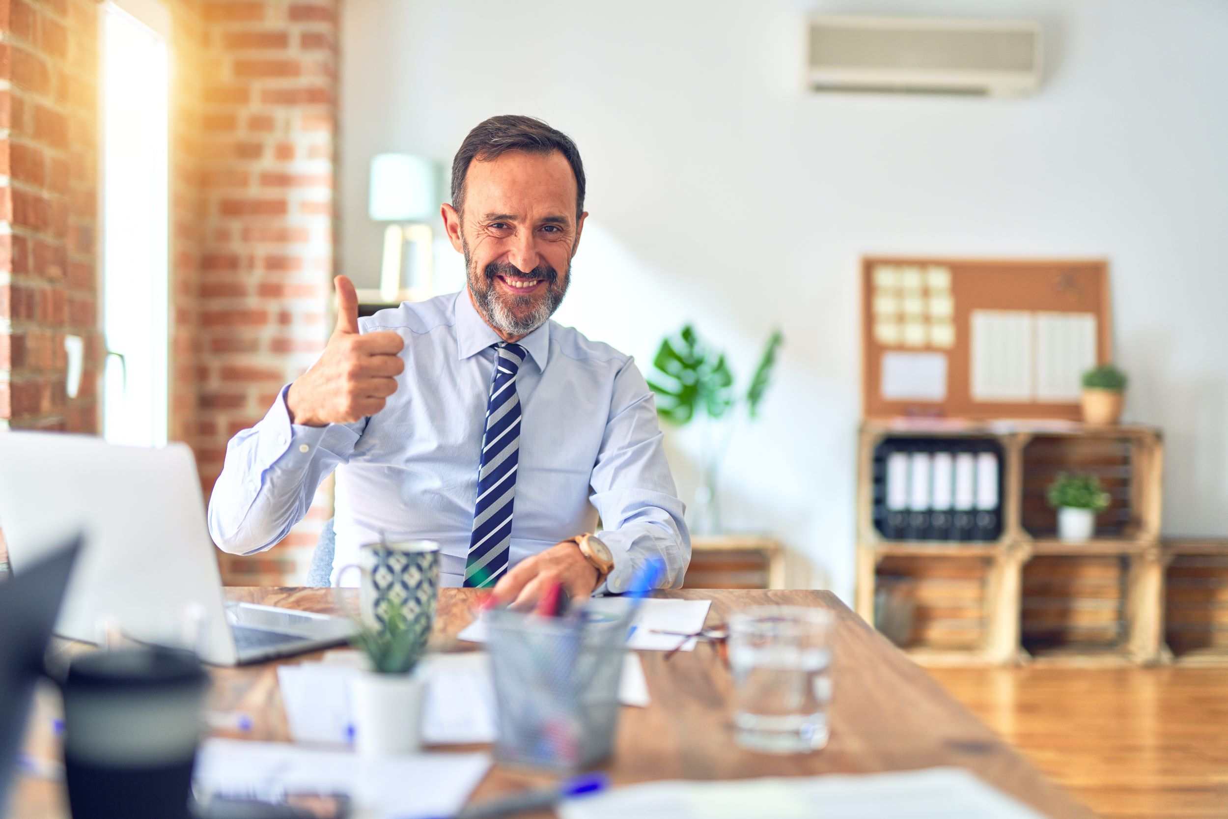 person in an office giving thumbs up